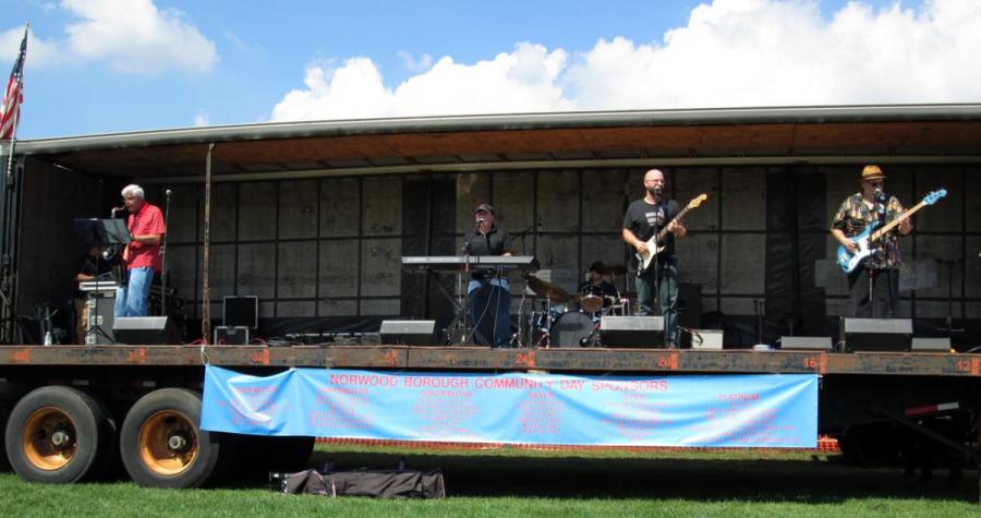 Sal with full band playing piano on Norwood stage